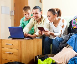 happy family three reserving hotel internet using laptop